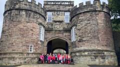 Skipton Castle with our children at the entrance 