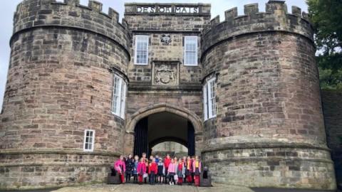 Skipton Castle with our children at the entrance 